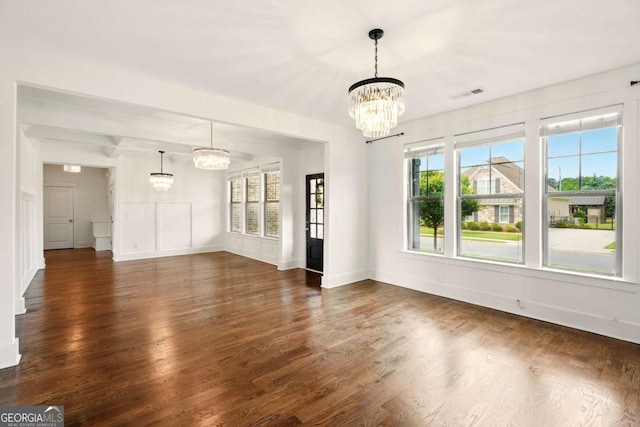 847 Rolling Hl, Kennesaw, GA 30152 - unfurnished living room with a chandelier, dark wood-style floors, healthy amount of natural light, and baseboards