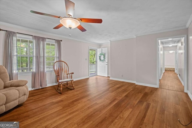 1267 Austin Bridge Rd, Douglasville, GA 30134 - living room featuring attic access, light wood-type flooring, ceiling fan, and crown molding