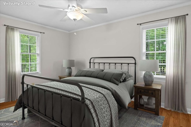 1267 Austin Bridge Rd, Douglasville, GA 30134 - bedroom with multiple windows, wood finished floors, crown molding, and ceiling fan