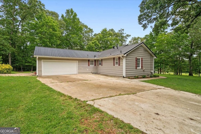 1267 Austin Bridge Rd, Douglasville, GA 30134 - ranch-style home with driveway, a garage, a front yard, a metal roof, and view of wooded area