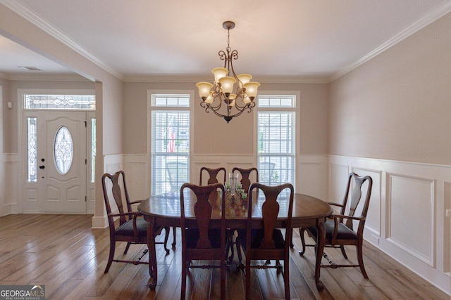 319 Beaconsfield Dr, Sharpsburg, GA 30277 - dining area featuring a decorative wall, healthy amount of natural light, dark wood-type flooring, a chandelier, and a wainscoted wall