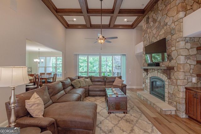 319 Beaconsfield Dr, Sharpsburg, GA 30277 - living area with light wood finished floors, ceiling fan, coffered ceiling, beamed ceiling, and a stone fireplace