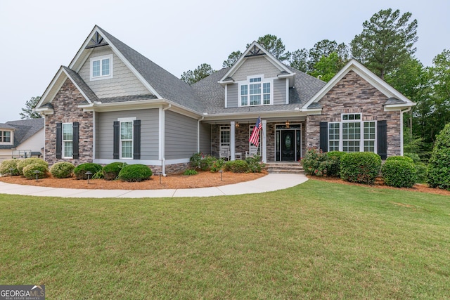 319 Beaconsfield Dr, Sharpsburg, GA 30277 - craftsman inspired home featuring stone siding, a front lawn, a porch, and roof with shingles