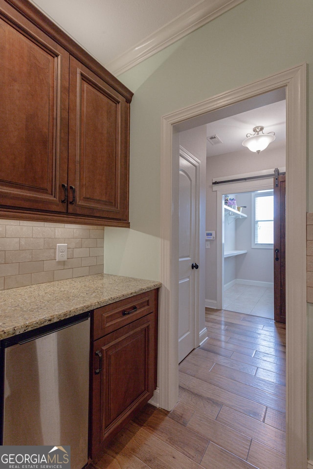 319 Beaconsfield Dr, Sharpsburg, GA 30277 - kitchen with tasteful backsplash, baseboards, light stone countertops, light wood-style floors, and ornamental molding