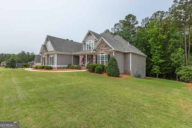 319 Beaconsfield Dr, Sharpsburg, GA 30277 - view of front facade with stone siding, a front lawn, roof with shingles, and central AC