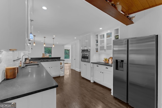 2596 Midway Rd, Decatur, GA 30030 - kitchen featuring stainless steel appliances, a sink, a peninsula, dark countertops, and white cabinets