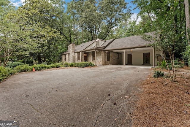 2596 Midway Rd, Decatur, GA 30030 - view of front facade with asphalt driveway, stone siding, a carport, and a chimney
