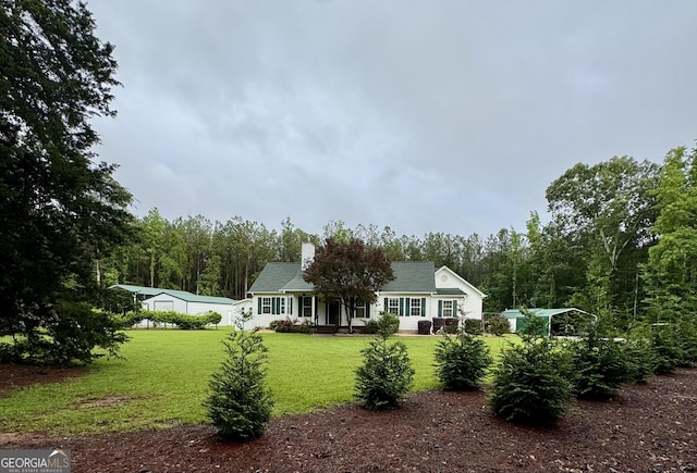 4288 Ga Highway 16 W, Monticello, GA 31064 - back of house featuring a lawn, a chimney, and a forest view