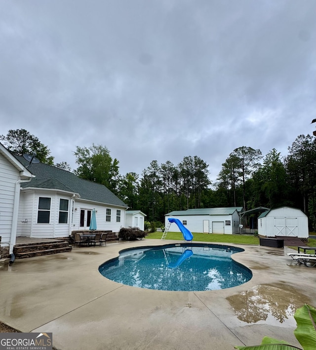4288 Ga Highway 16 W, Monticello, GA 31064 - swimming pool with a water slide, a patio, and view of wooded area