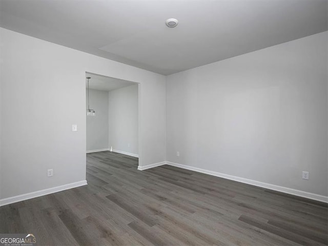 250 Shawnee Trl, Dallas, GA 30157 - unfurnished room featuring dark wood-type flooring and a chandelier