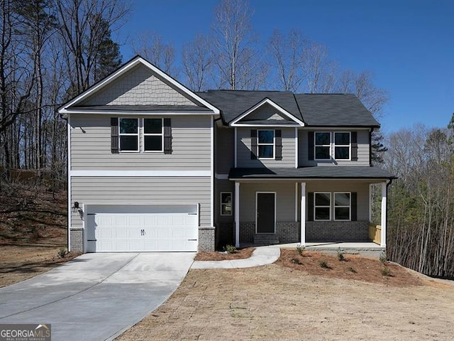 250 Shawnee Trl, Dallas, GA 30157 - view of front facade with concrete driveway, an attached garage, covered porch, and brick siding