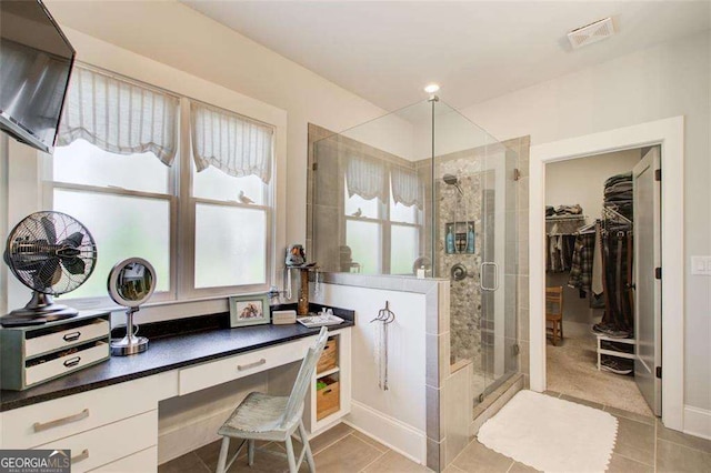 164 Inwood Walk, Woodstock, GA 30188 - bathroom featuring a shower stall, a walk in closet, and tile patterned flooring