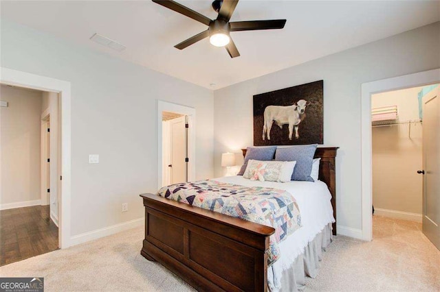 164 Inwood Walk, Woodstock, GA 30188 - bedroom featuring light carpet, a spacious closet, baseboards, ceiling fan, and a closet