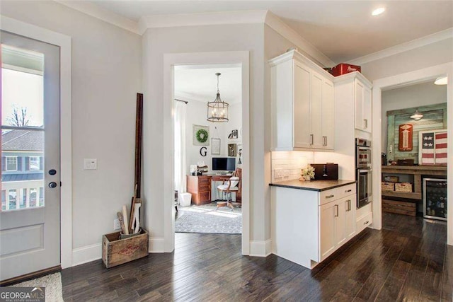 164 Inwood Walk, Woodstock, GA 30188 - bar featuring dark wood-type flooring, crown molding, double oven, wine cooler, and baseboards