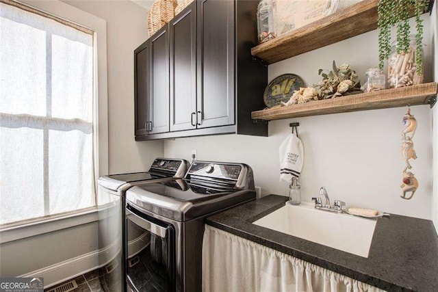 164 Inwood Walk, Woodstock, GA 30188 - laundry area featuring cabinet space, washing machine and clothes dryer, plenty of natural light, and baseboards