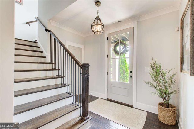 164 Inwood Walk, Woodstock, GA 30188 - foyer with a chandelier, stairs, dark wood-style floors, baseboards, and crown molding