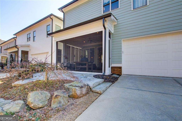 164 Inwood Walk, Woodstock, GA 30188 - view of side of home featuring a sunroom, an attached garage, and concrete driveway