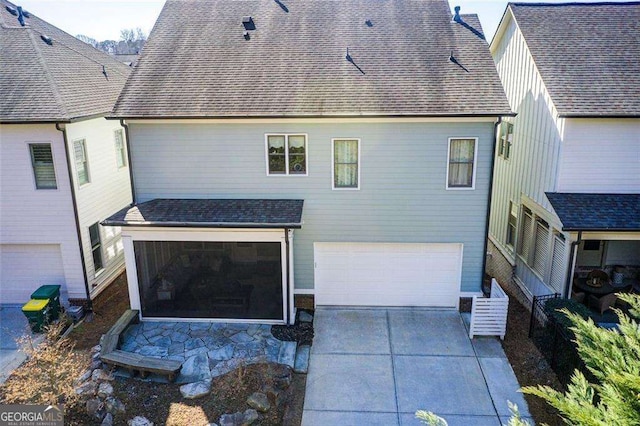 164 Inwood Walk, Woodstock, GA 30188 - back of property featuring a garage, concrete driveway, and roof with shingles