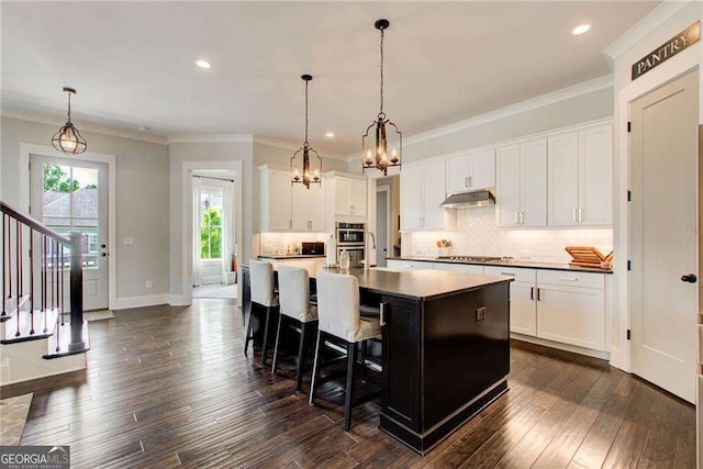 164 Inwood Walk, Woodstock, GA 30188 - kitchen with a chandelier, appliances with stainless steel finishes, tasteful backsplash, white cabinets, and crown molding
