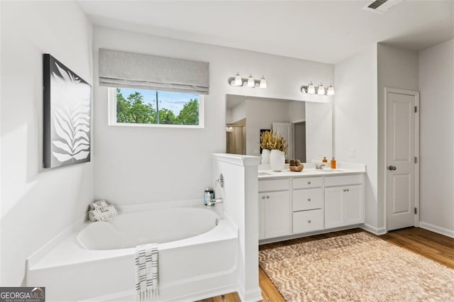 820 Dobby Way Lot 99, Mcdonough, GA 30252 - full bath with double vanity, a garden tub, wood finished floors, and a shower