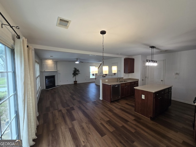 3613 Tinsley Way, Atlanta, GA 30331 - kitchen featuring dishwasher, light countertops, a glass covered fireplace, open floor plan, and dark wood-type flooring