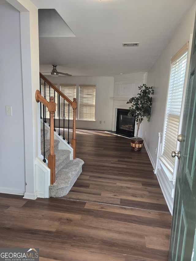 3613 Tinsley Way, Atlanta, GA 30331 - unfurnished living room featuring dark wood-type flooring, stairway, a ceiling fan, and a glass covered fireplace