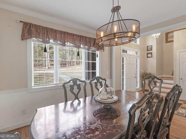 355 Parker Rd, Covington, GA 30014 - dining room with a chandelier, crown molding, wood finished floors, and stairway