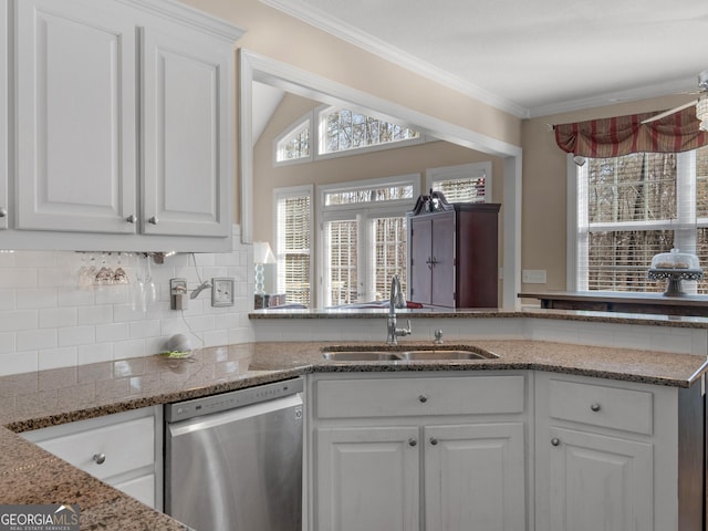 355 Parker Rd, Covington, GA 30014 - kitchen with stainless steel dishwasher, white cabinetry, decorative backsplash, ornamental molding, and light stone countertops