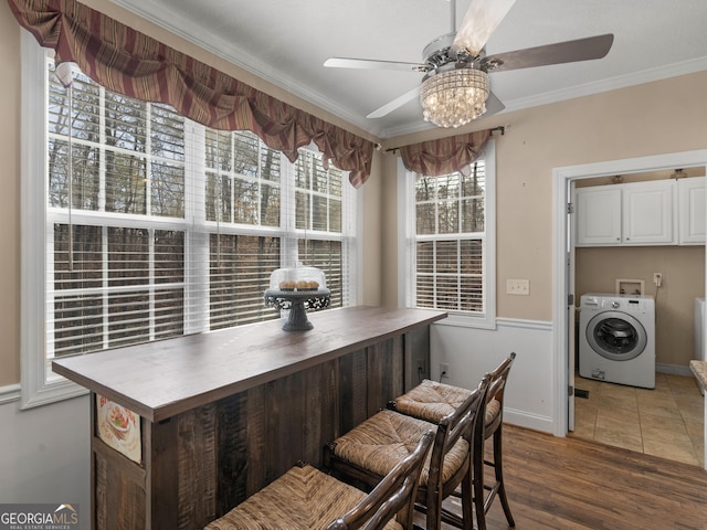 355 Parker Rd, Covington, GA 30014 - dining room with washer / dryer, ceiling fan, crown molding, and wood finished floors