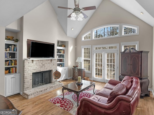 355 Parker Rd, Covington, GA 30014 - living area with wood finished floors, built in features, a fireplace, a ceiling fan, and high vaulted ceiling