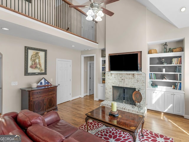 355 Parker Rd, Covington, GA 30014 - living room featuring a ceiling fan, light wood-type flooring, high vaulted ceiling, a fireplace, and recessed lighting