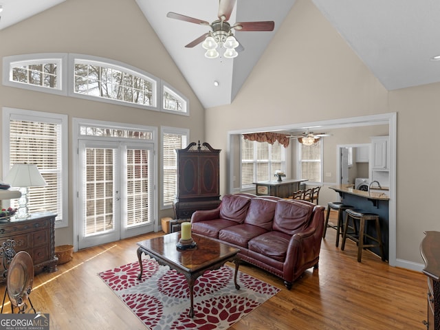 355 Parker Rd, Covington, GA 30014 - living area featuring ceiling fan, high vaulted ceiling, wood finished floors, and french doors