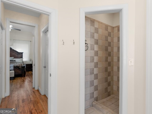 355 Parker Rd, Covington, GA 30014 - bathroom with a tile shower and wood finished floors