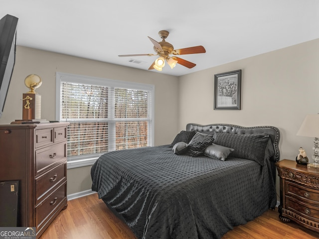 355 Parker Rd, Covington, GA 30014 - bedroom with light wood finished floors and ceiling fan
