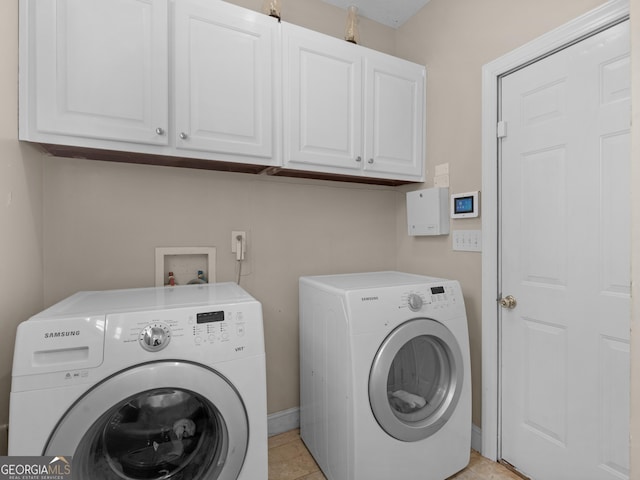 355 Parker Rd, Covington, GA 30014 - laundry area featuring washer and clothes dryer, cabinet space, and light tile patterned flooring