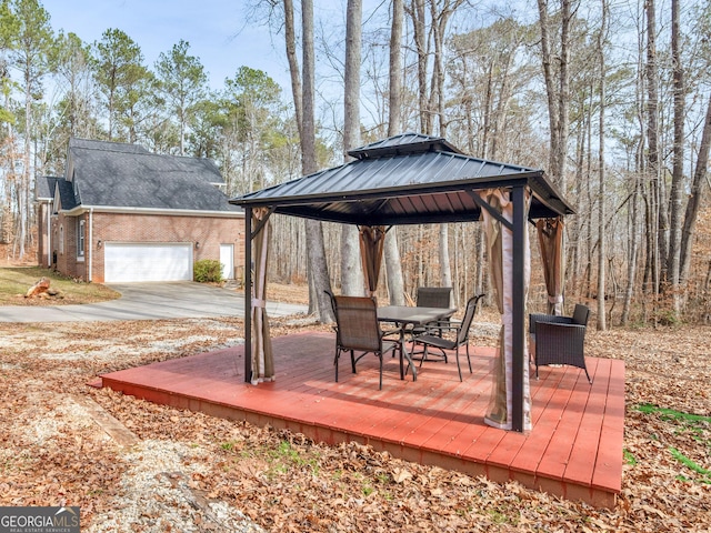 355 Parker Rd, Covington, GA 30014 - wooden terrace with a gazebo, outdoor dining area, and concrete driveway