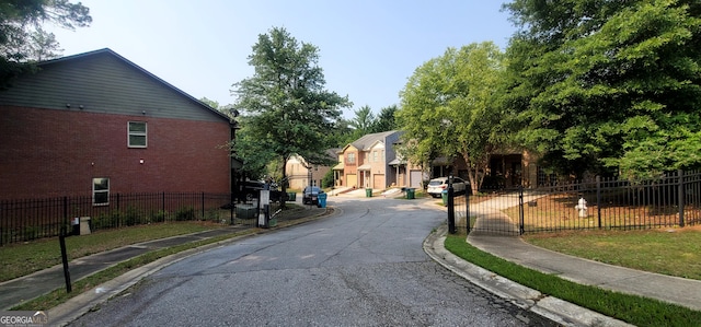 5719 Singlebriar Ct, Norcross, GA 30093 - view of asphalt road with sidewalks, curbs, and a gate