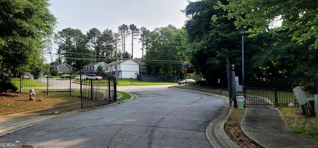 5719 Singlebriar Ct, Norcross, GA 30093 - view of asphalt street featuring sidewalks, street lights, a gate, and curbs