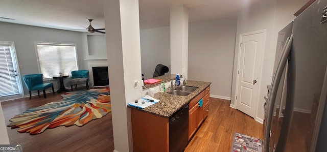 5719 Singlebriar Ct, Norcross, GA 30093 - kitchen with freestanding refrigerator, a sink, black dishwasher, ceiling fan, and light wood-style flooring