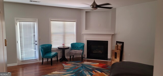 5719 Singlebriar Ct, Norcross, GA 30093 - sitting room with ceiling fan, a glass covered fireplace, wood finished floors, and baseboards