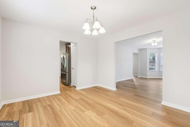 6230 Lillie Ln, Cumming, GA 30040 - empty room with a chandelier, light wood-style flooring, and baseboards
