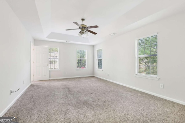 6230 Lillie Ln, Cumming, GA 30040 - carpeted empty room with plenty of natural light, a tray ceiling, a ceiling fan, and baseboards