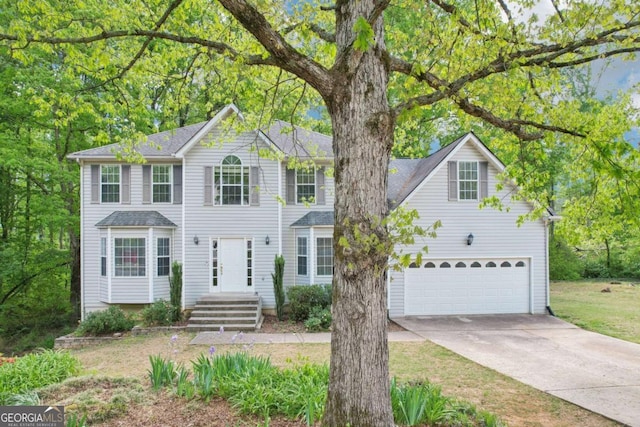 6230 Lillie Ln, Cumming, GA 30040 - view of front facade with concrete driveway, a garage, and a shingled roof