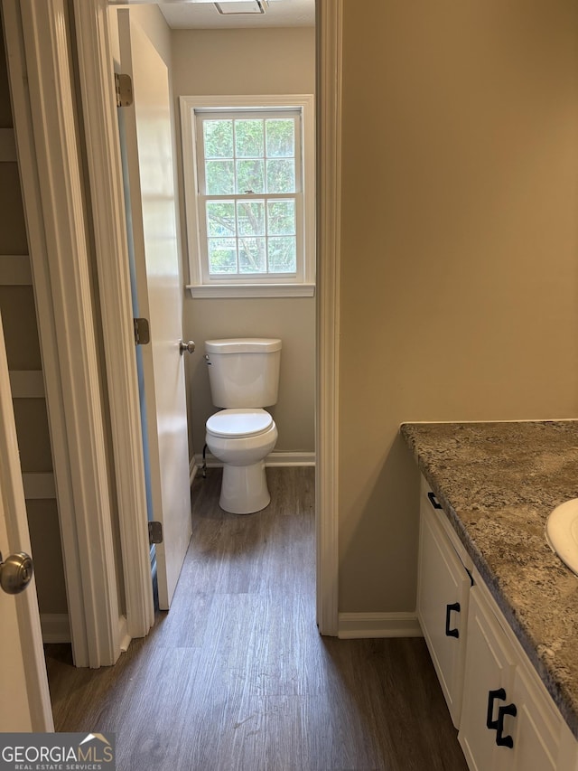6103 Chaseland Rd, Rex, GA 30273 - bathroom featuring wood finished floors, baseboards, vanity, and toilet