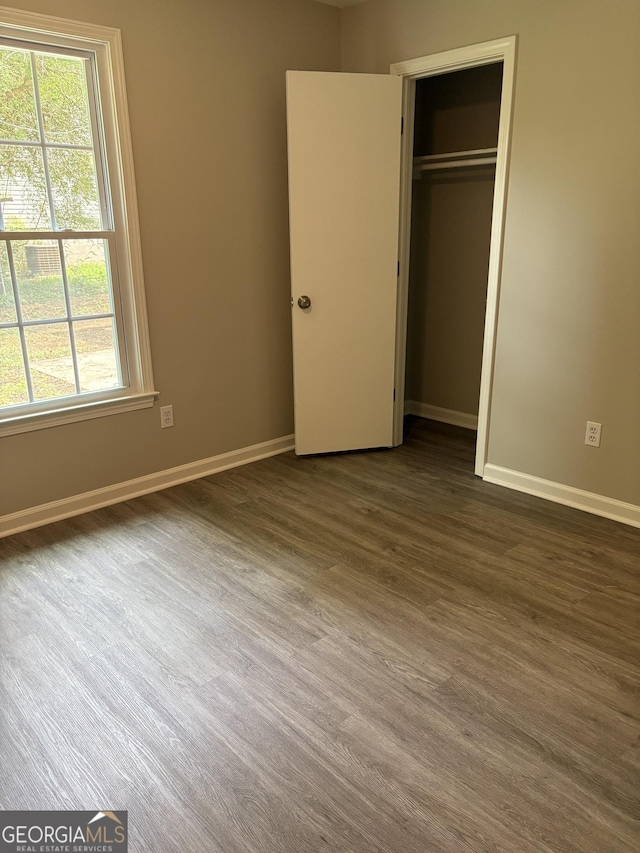 6103 Chaseland Rd, Rex, GA 30273 - unfurnished bedroom featuring baseboards, multiple windows, and dark wood finished floors