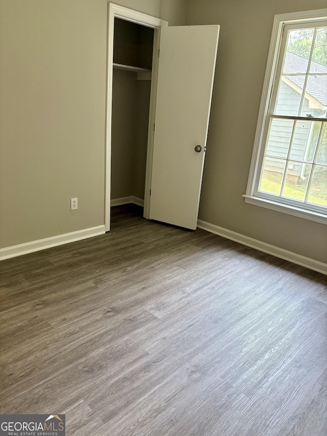 6103 Chaseland Rd, Rex, GA 30273 - unfurnished bedroom with baseboards, a closet, and wood finished floors