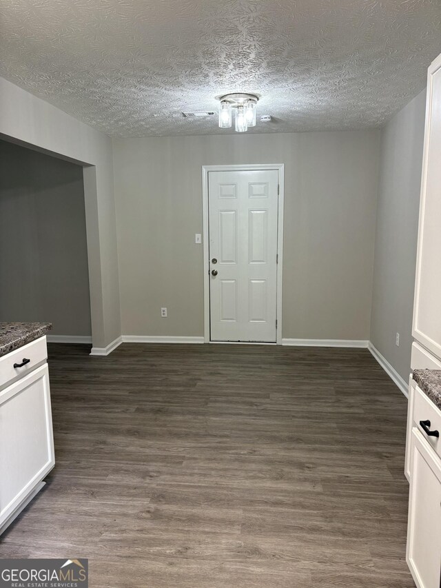 6103 Chaseland Rd, Rex, GA 30273 - entryway with a textured ceiling, baseboards, and dark wood-type flooring