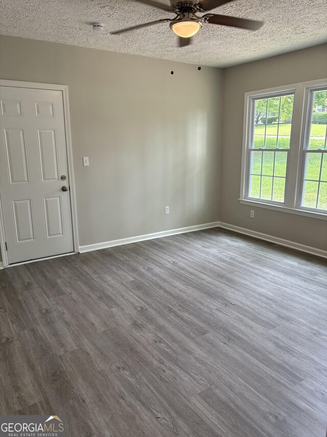 6103 Chaseland Rd, Rex, GA 30273 - unfurnished room featuring ceiling fan, dark wood-style floors, baseboards, and a textured ceiling