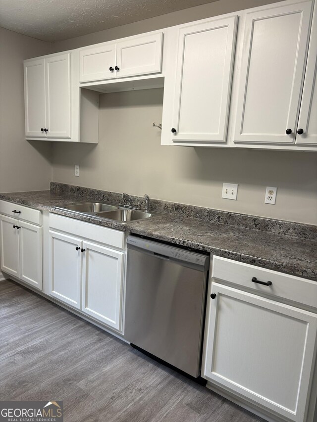6103 Chaseland Rd, Rex, GA 30273 - kitchen with stainless steel dishwasher, a sink, white cabinetry, wood finished floors, and dark countertops