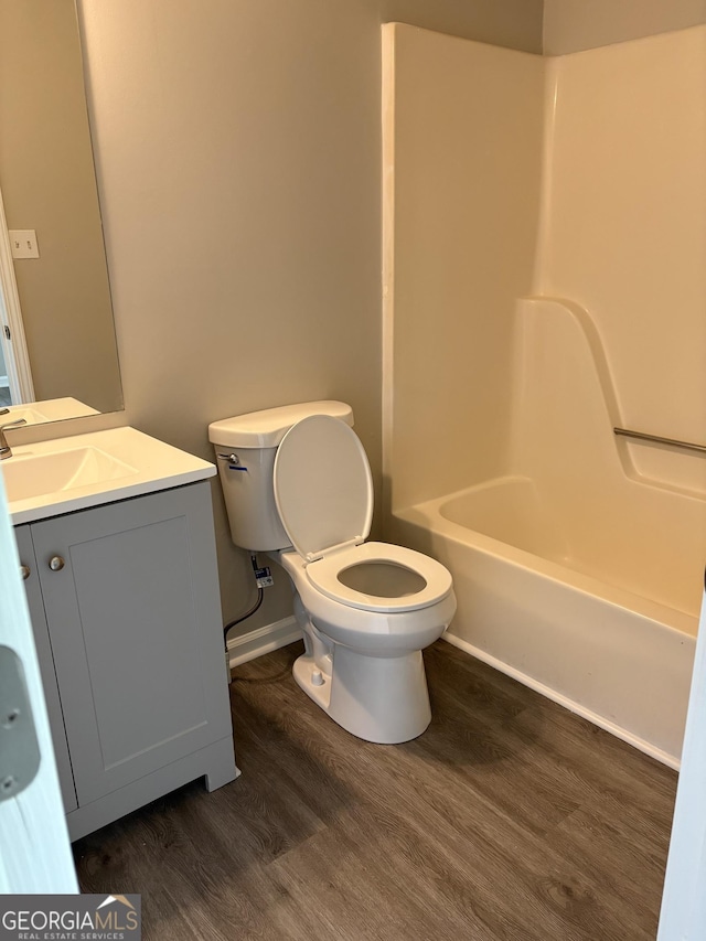 6103 Chaseland Rd, Rex, GA 30273 - bathroom with wood finished floors, toilet, vanity, bathing tub / shower combination, and baseboards